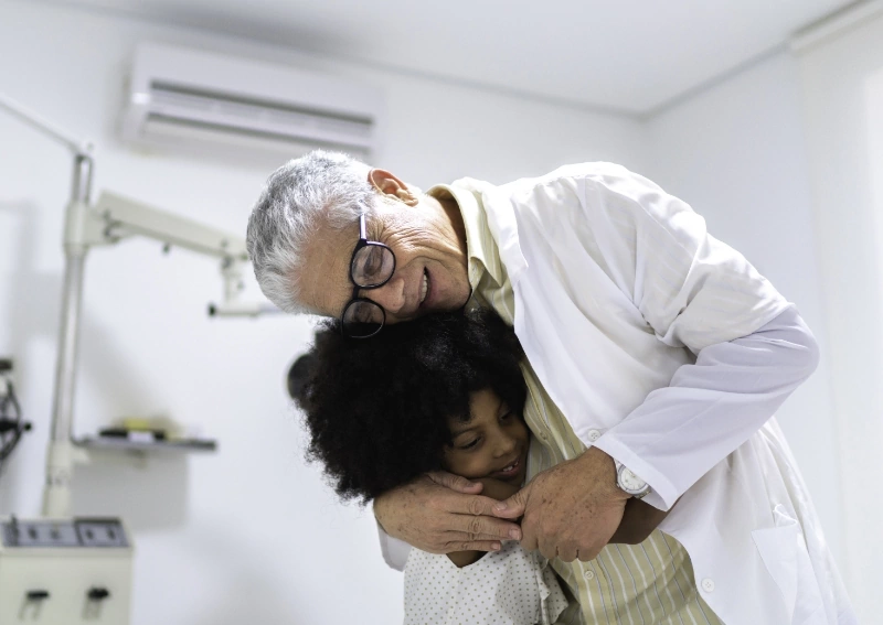 a doctor hugs a young patient